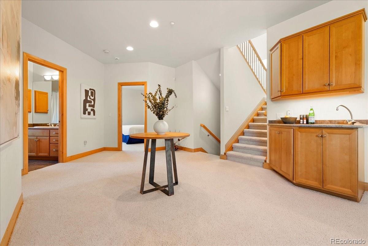 20682 Falcon Wing Road Indian Hills, CO 80454 - Photo 36 of 45 a view of a livingroom with furniture furniture staircase and windows