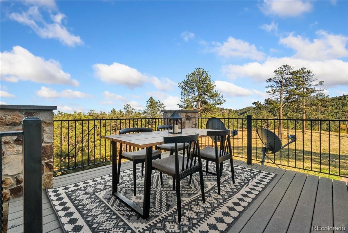 20682 Falcon Wing Road Indian Hills, CO 80454 - Photo 40 of 50 a view of a balcony with chairs