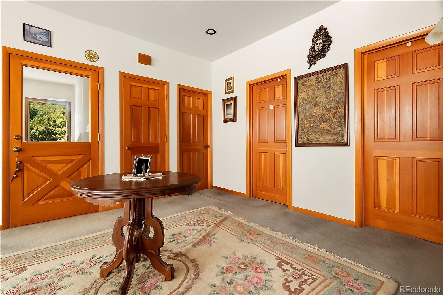 20682 Falcon Wing Road Indian Hills, CO 80454 - Photo 41 of 45 a view of a room with furniture and wooden floor