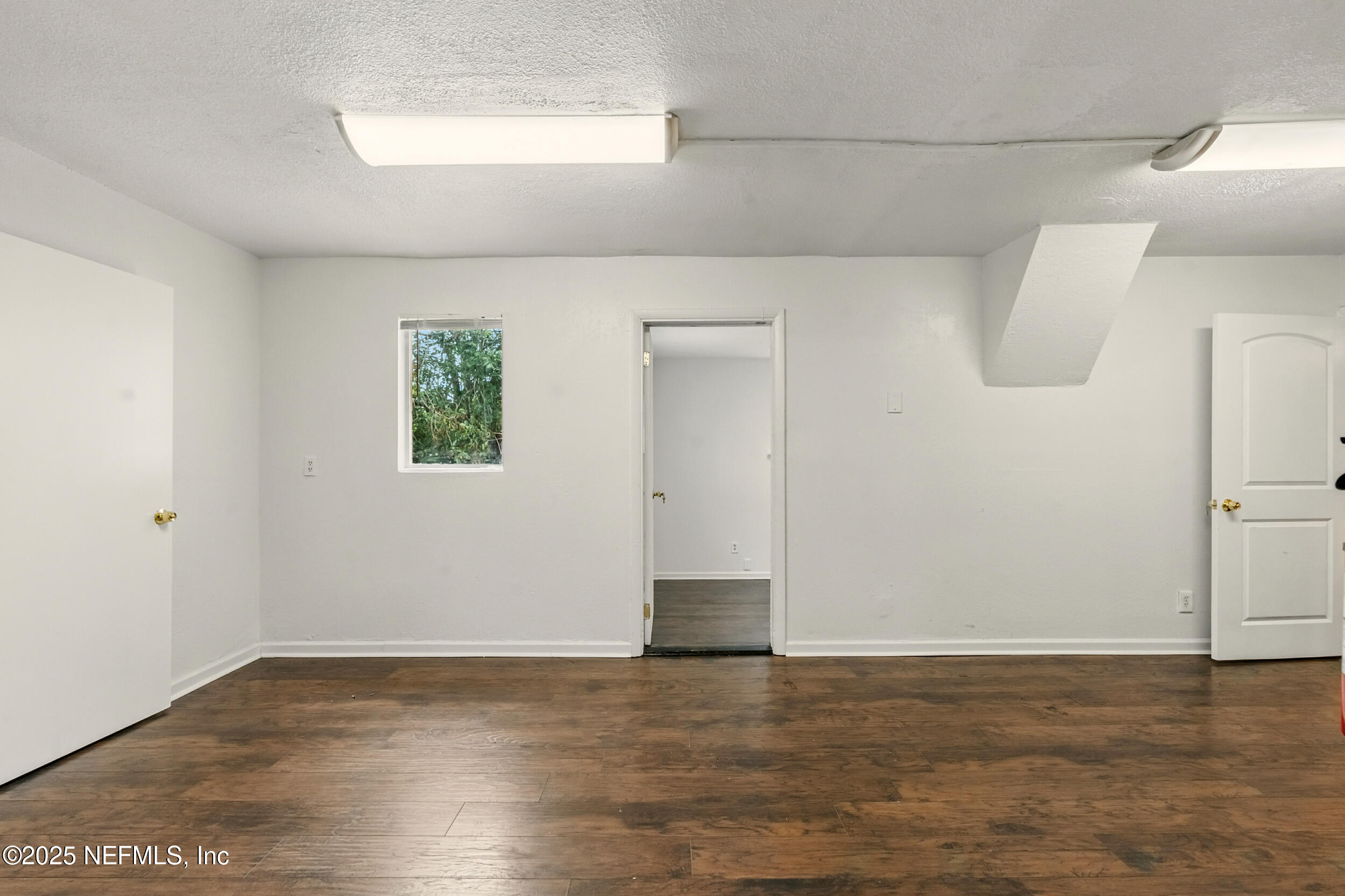 7120 Merrill Road Jacksonville, FL 32211 - Photo 11 of 60 a view of a room with wooden floor and cabinet