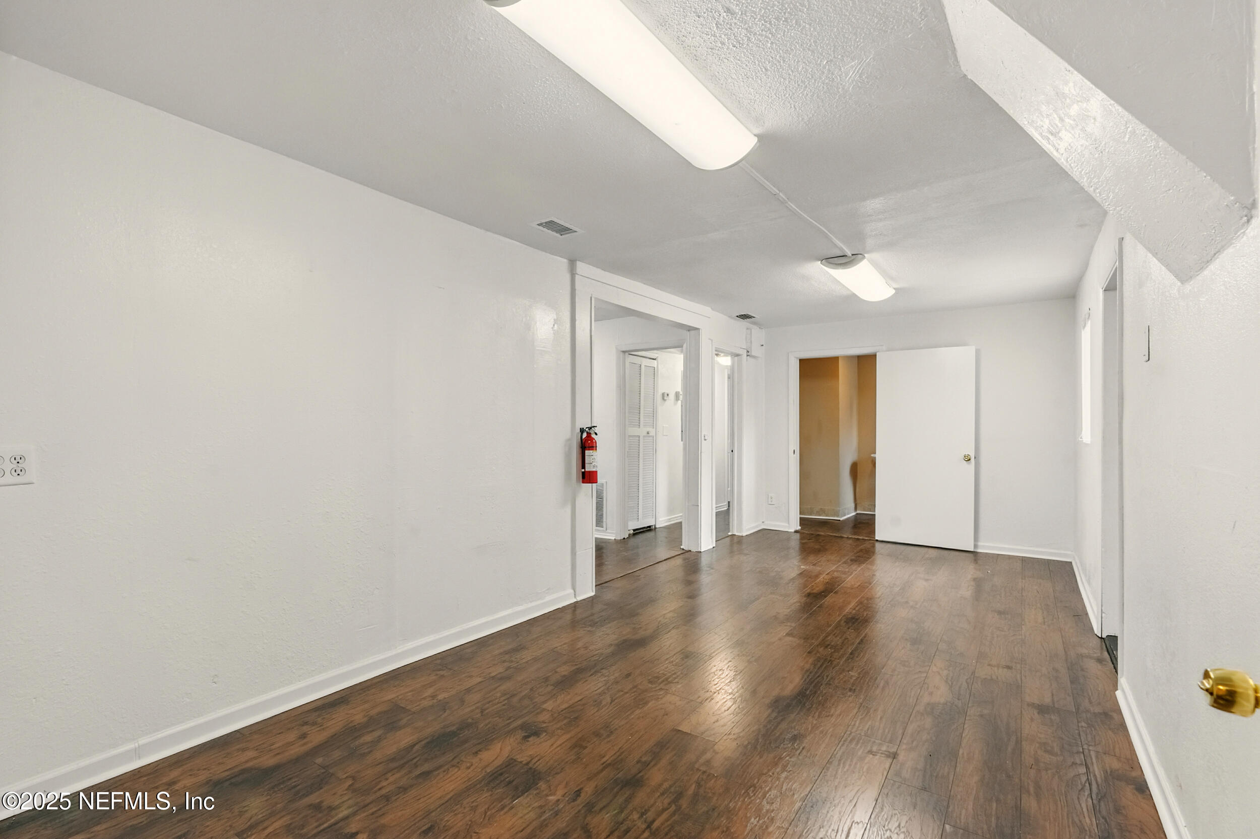 7120 Merrill Road Jacksonville, FL 32211 - Photo 15 of 60 a view of an empty room with wooden floor