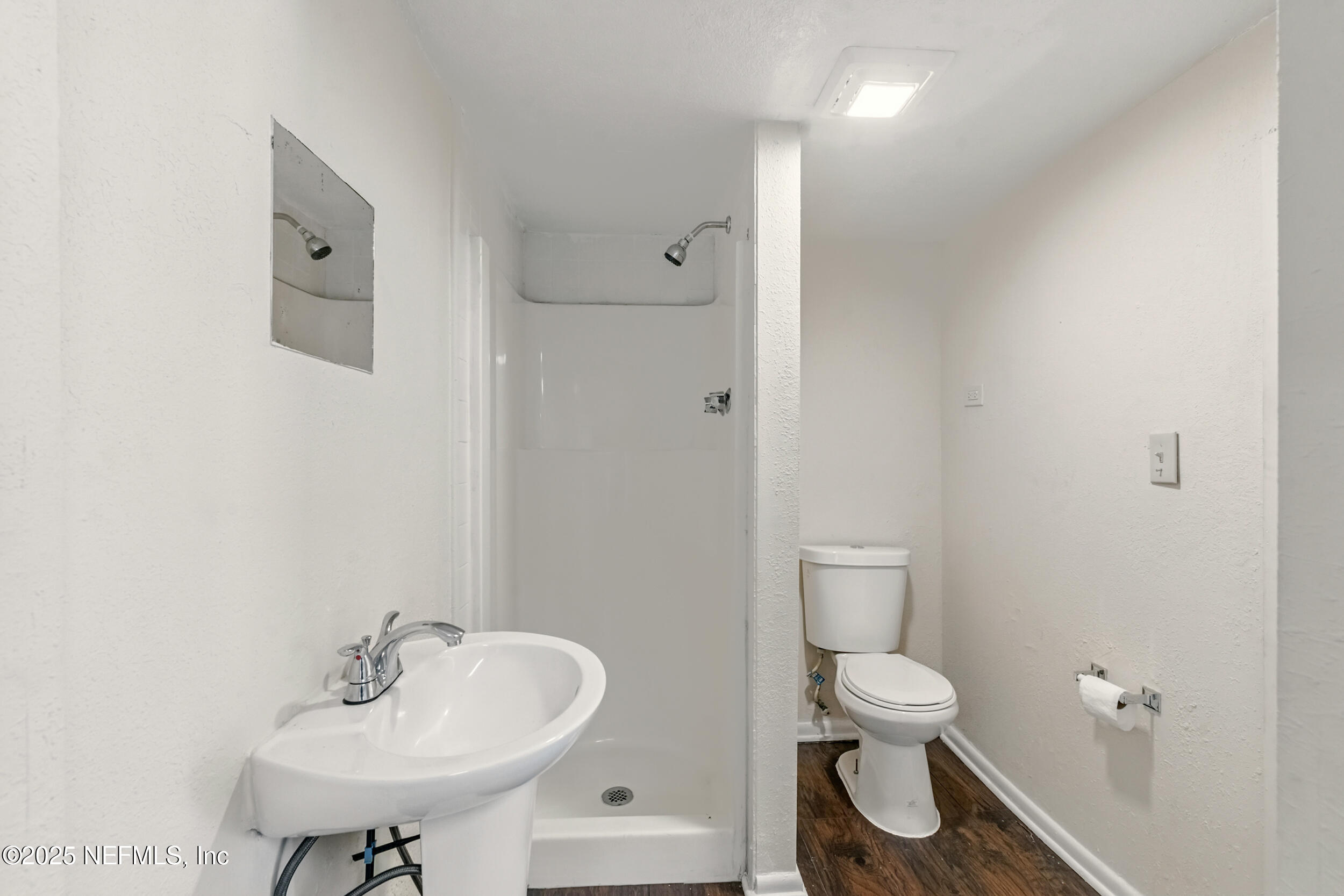 7120 Merrill Road Jacksonville, FL 32211 - Photo 16 of 60 a bathroom with a toilet sink and a mirror