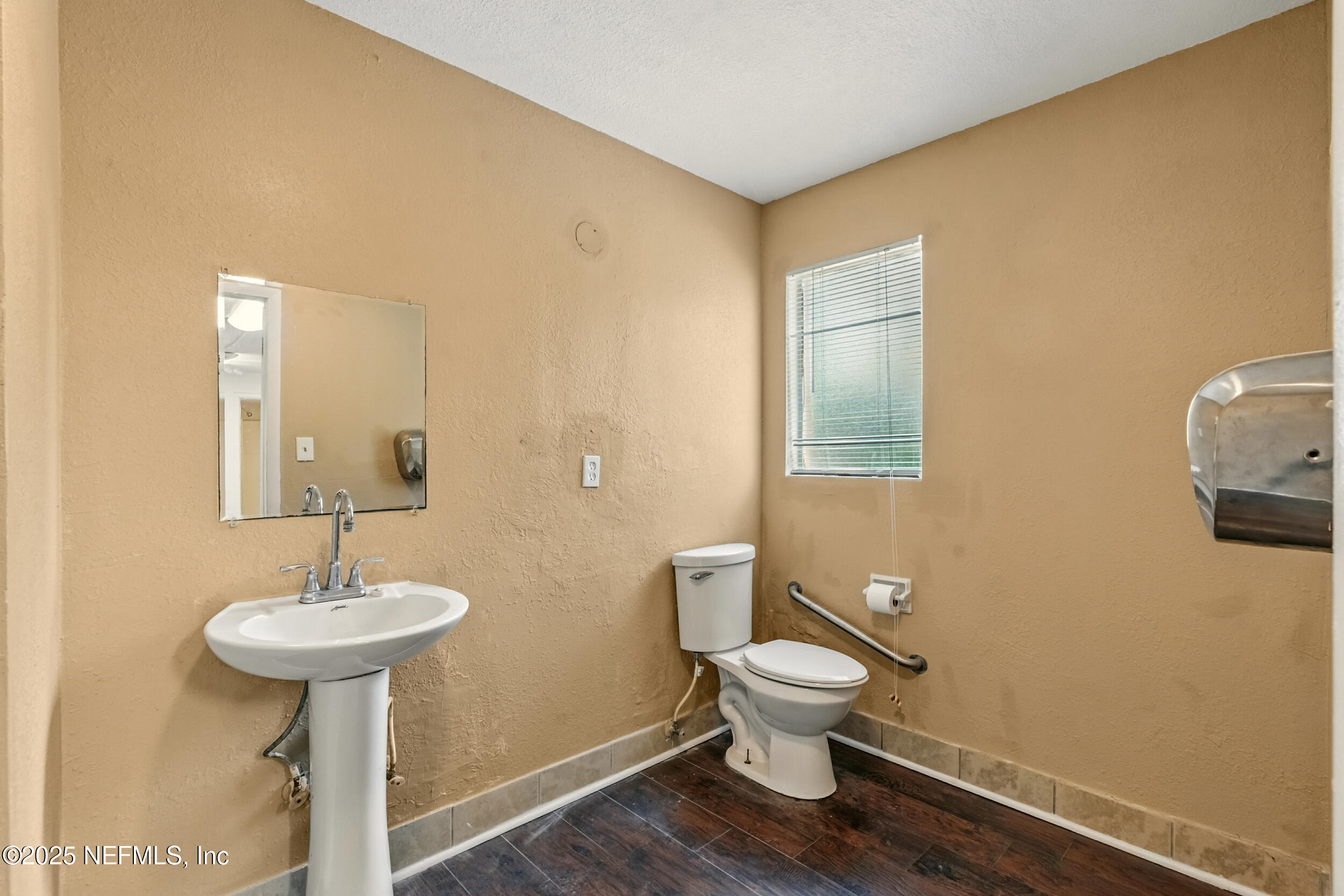 7120 Merrill Road Jacksonville, FL 32211 - Photo 20 of 60 a bathroom with a toilet a sink and mirror