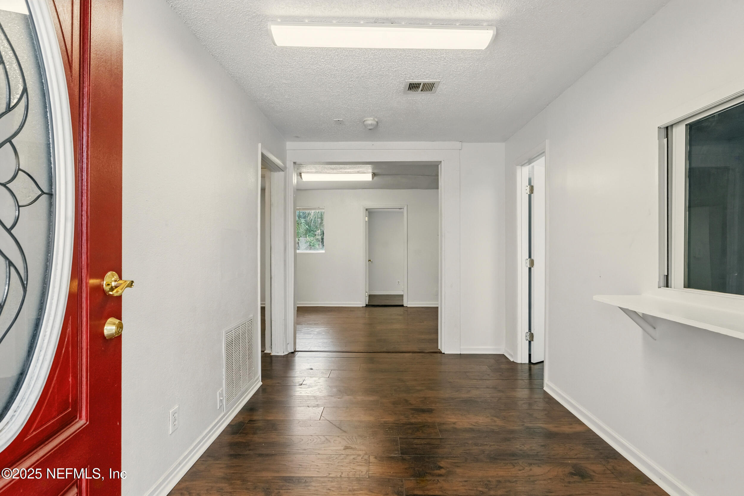 7120 Merrill Road Jacksonville, FL 32211 - Photo 9 of 60 a view of a hallway with wooden floor
