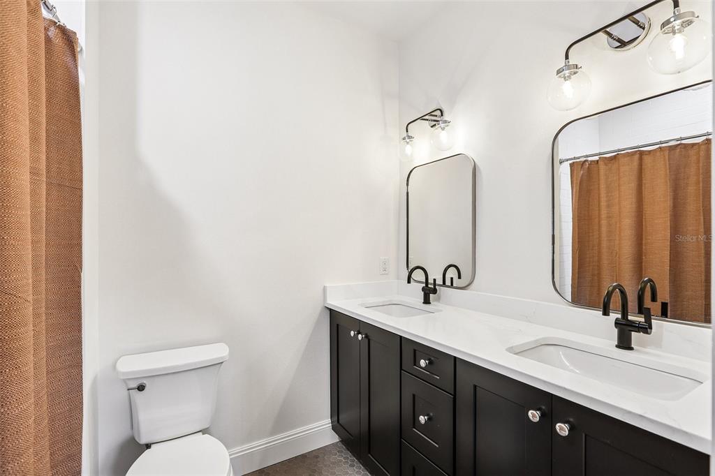 1012 Morfield Lane Brandon, FL 33511 - Photo 71 of 100 a bathroom with a double vanity sink and a mirror