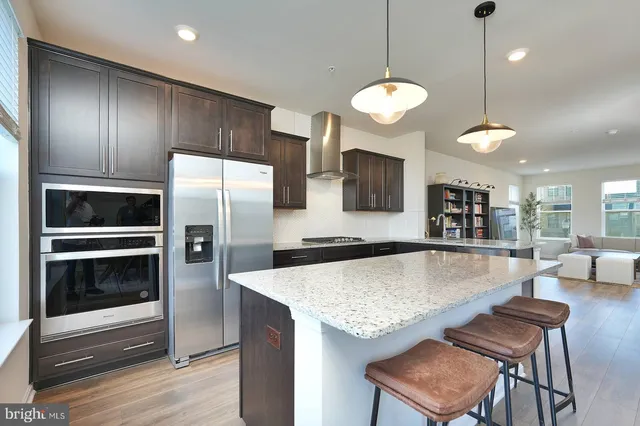 a kitchen with granite countertop a stove oven and refrigerator
