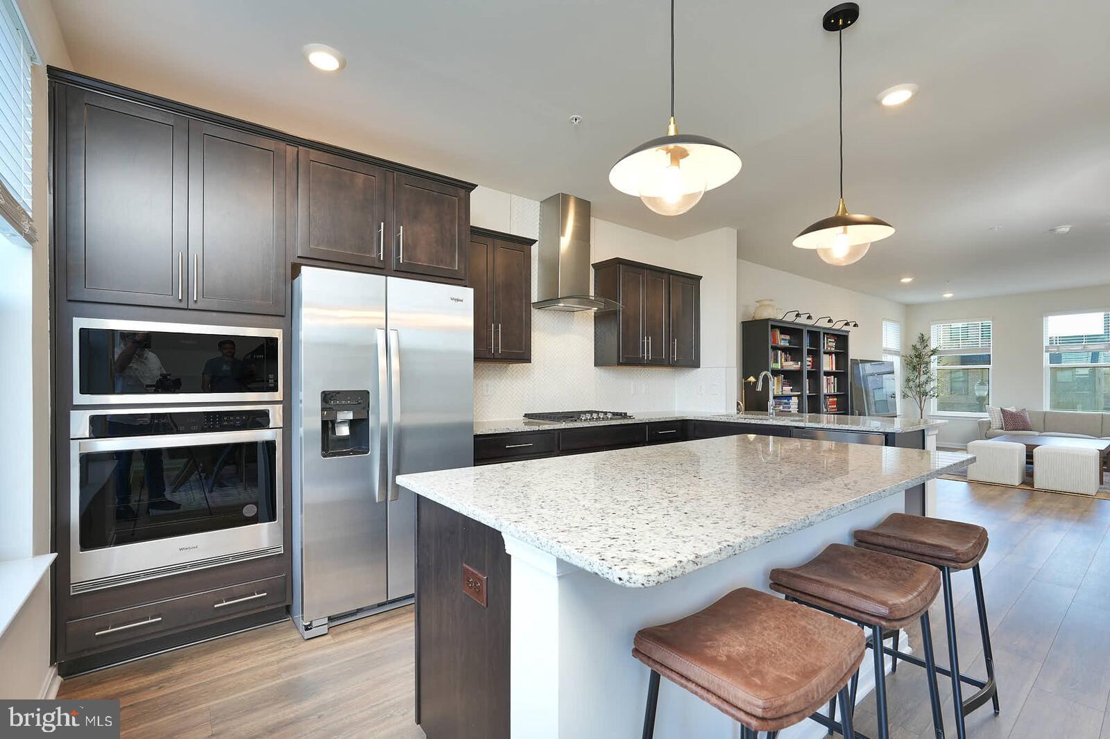 869 Amity Street Frederick, MD 21701 - Photo 14 of 48 a kitchen with granite countertop a stove oven and refrigerator