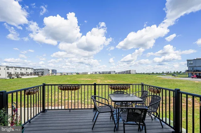a view of a balcony with lake view and wooden floor