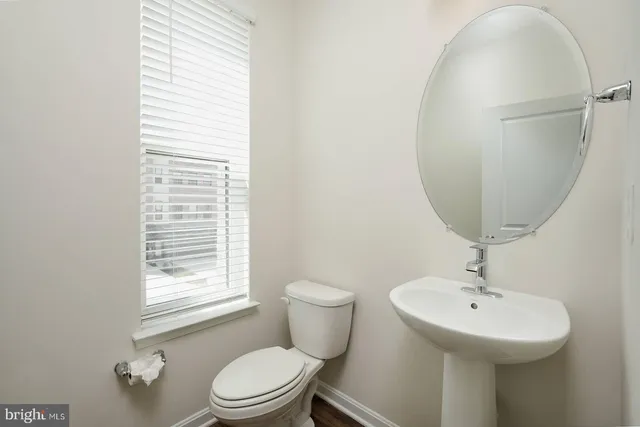 a bathroom with a sink a mirror and a toilet