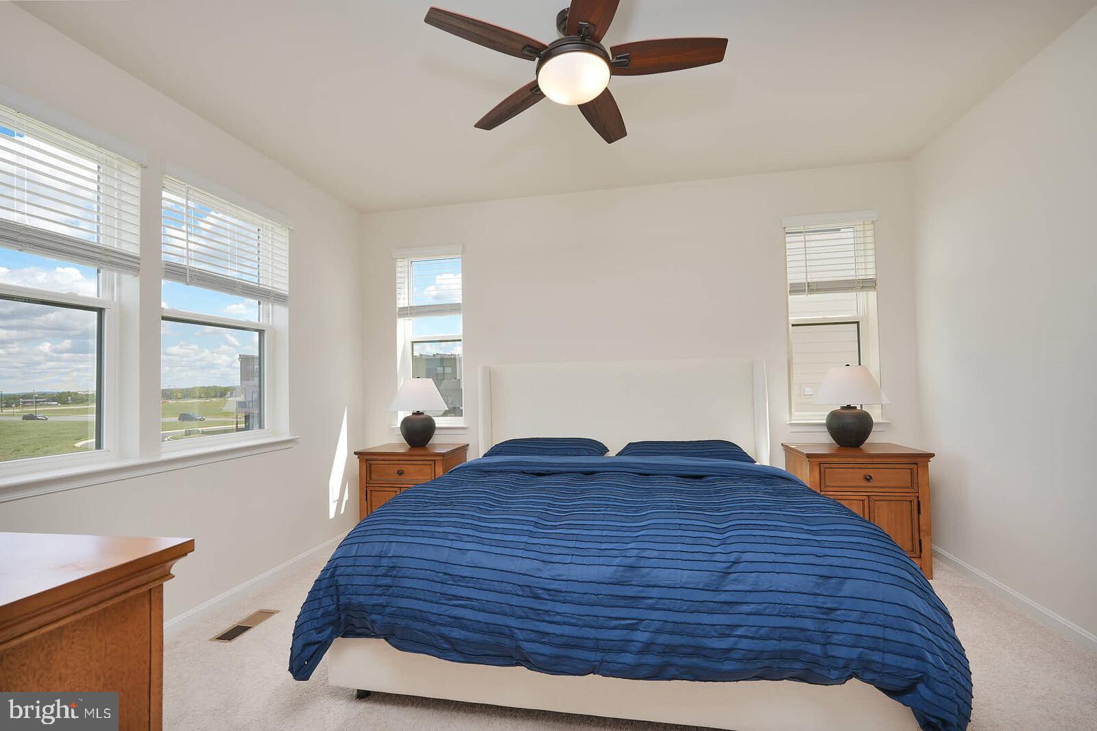 869 Amity Street Frederick, MD 21701 - Photo 27 of 48 a bed sitting in a bedroom next to a window
