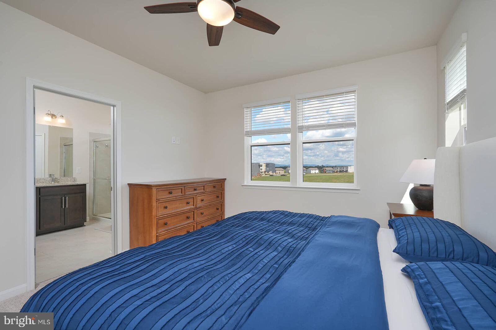 869 Amity Street Frederick, MD 21701 - Photo 28 of 48 a bedroom with a bed and a dresser with wooden floor