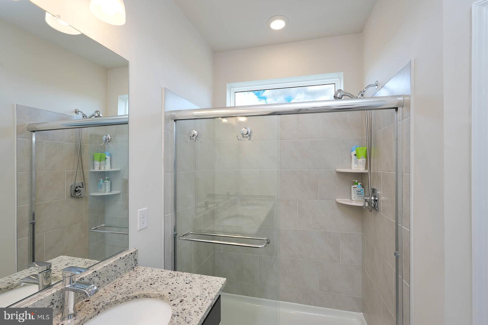 869 Amity Street Frederick, MD 21701 - Photo 30 of 48 a bathroom with a granite countertop bathtub shower and toilet
