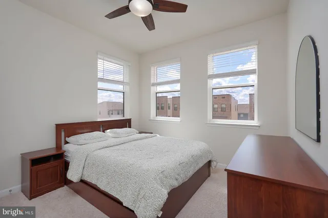 a bedroom with a large bed and a window