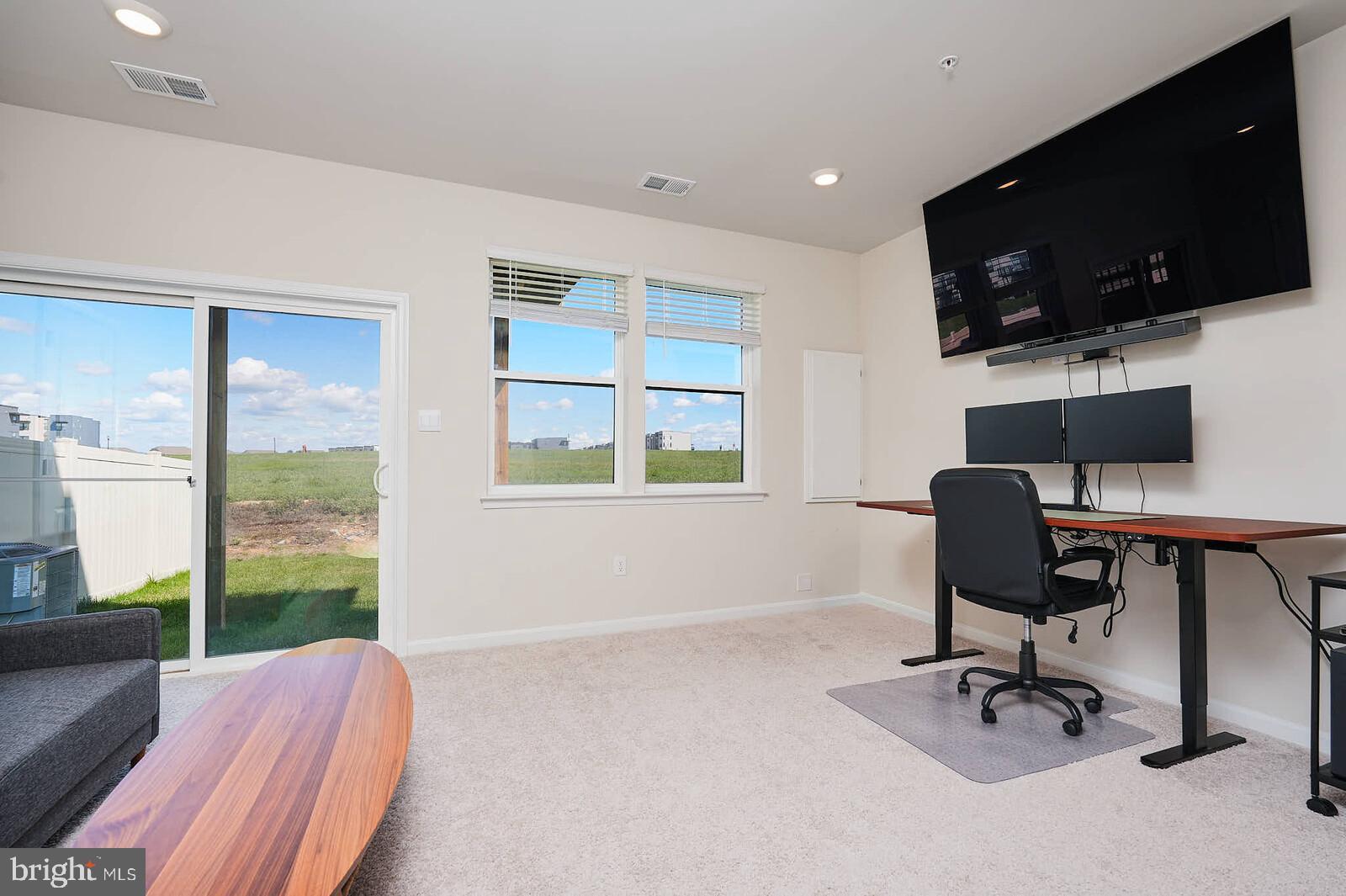 869 Amity Street Frederick, MD 21701 - Photo 4 of 48 a view of a workspace with furniture and a window