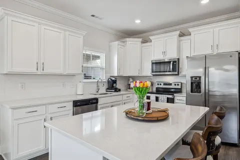 a kitchen with sink a stove and microwave