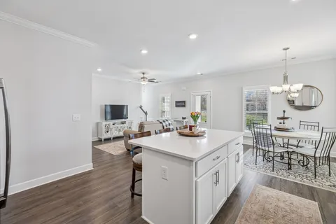 a view of kitchen island dining table and wooden floor