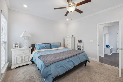 a bedroom with a large bed and a chandelier