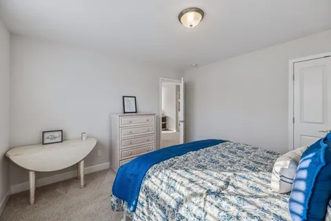 a bedroom with a bed and a chair