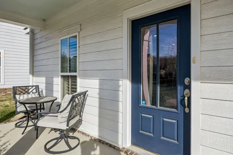 a view of a chair and table in front of house