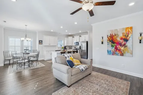 a living room with furniture and kitchen view