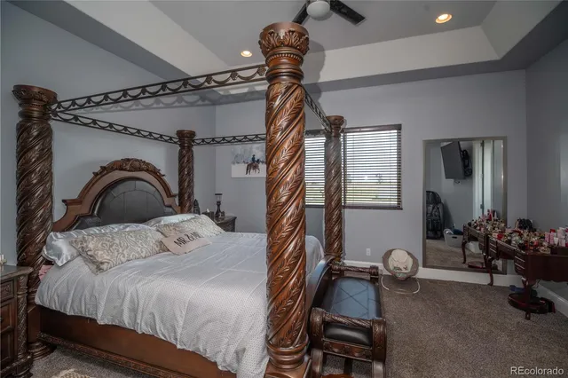 a bedroom with bed and a mirror