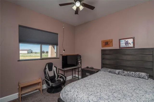 a bedroom with a bed a desk and chair