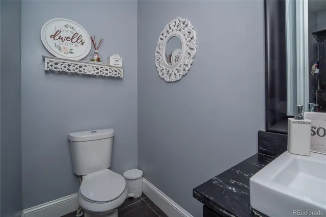 a white toilet sitting next to a bathroom sink