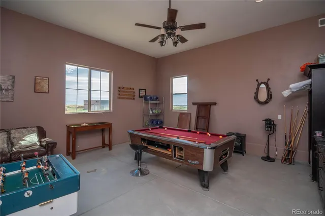 a room with furniture and pool table