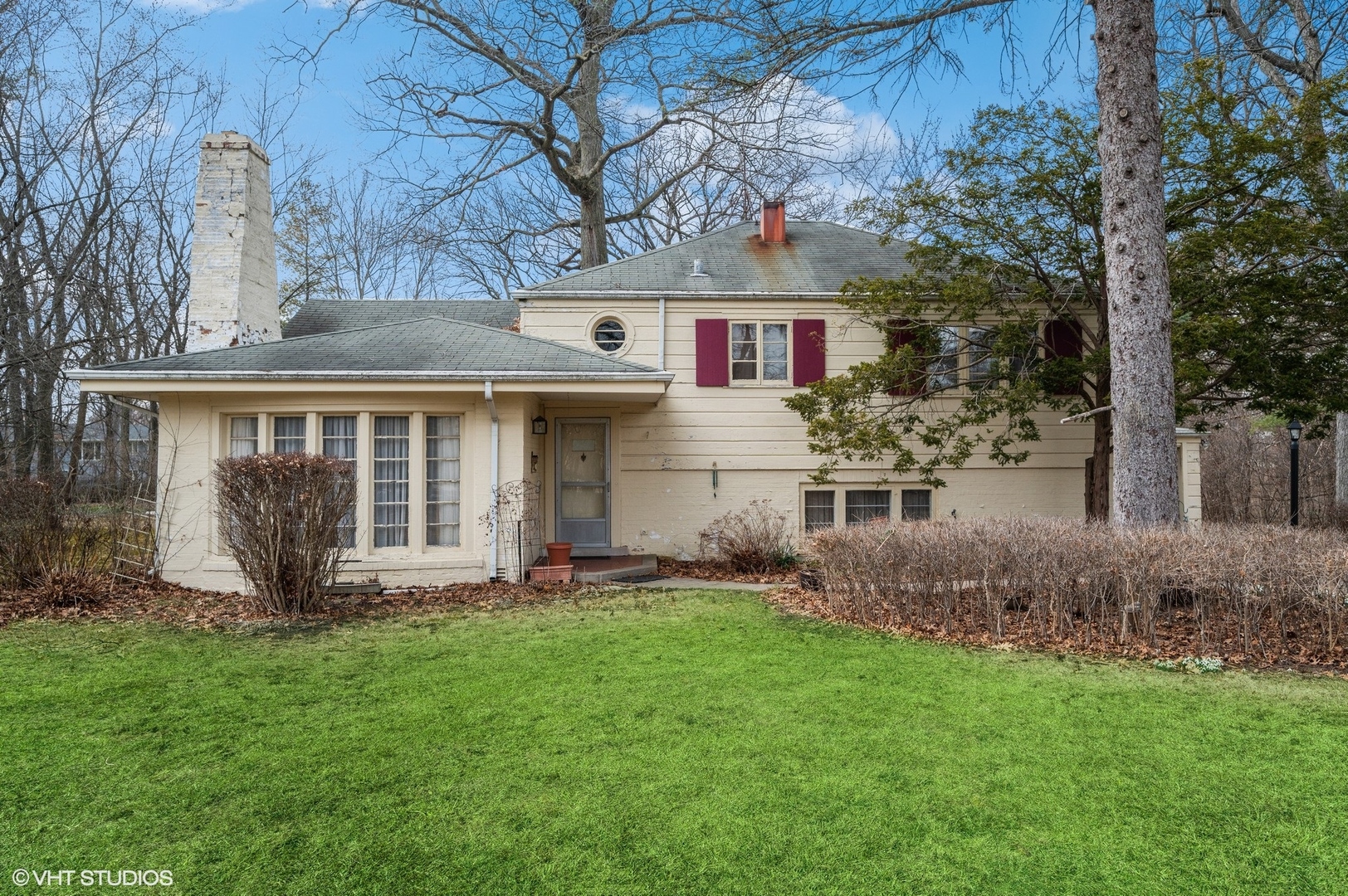 a front view of house with a garden