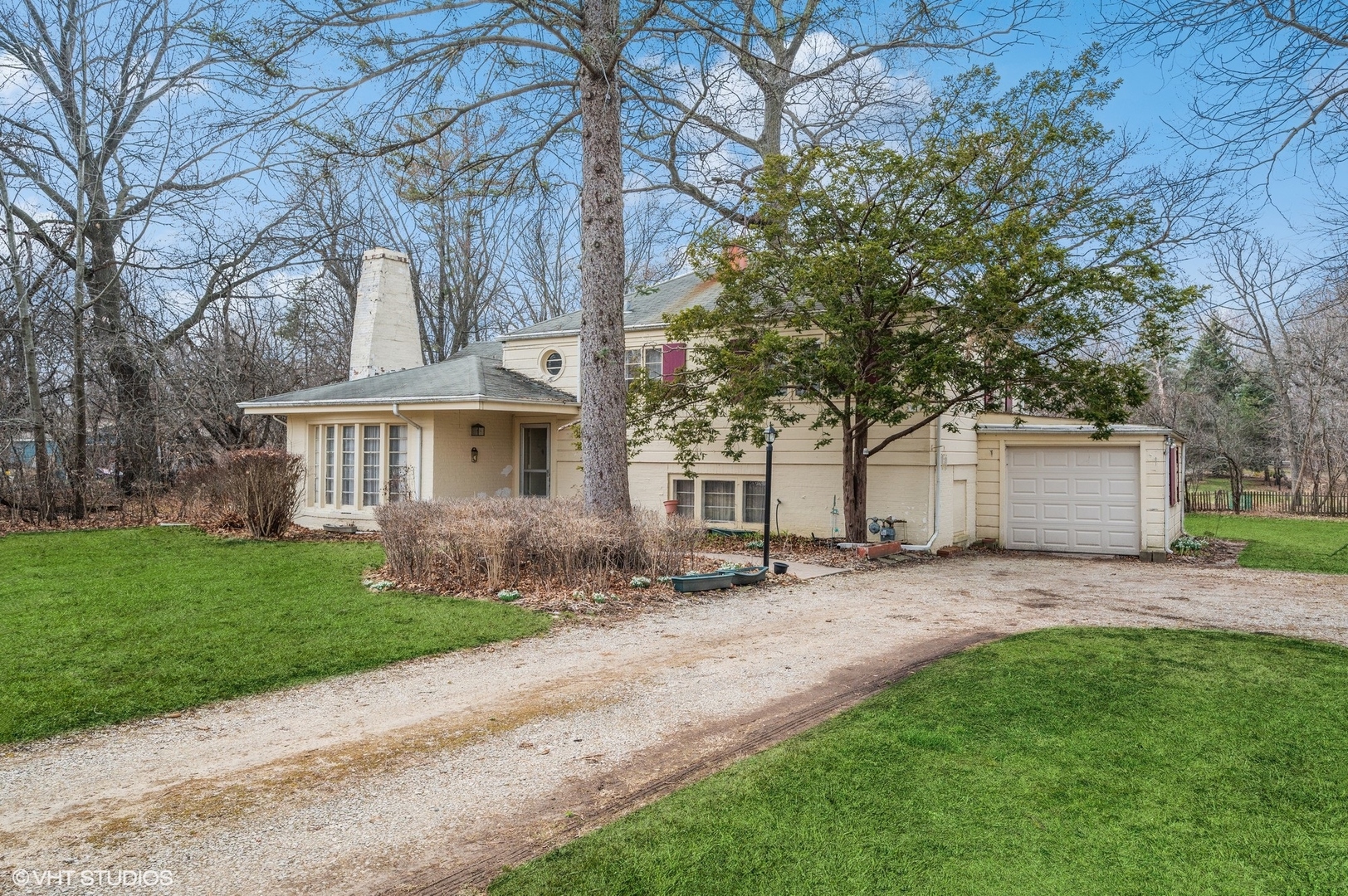 1628 South Meacham Road Rolling Meadows, IL 60008 - Photo 2 of 27 a front view of a house with a garden and trees