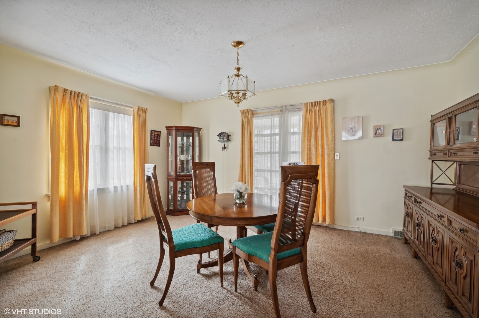 1628 South Meacham Road Rolling Meadows, IL 60008 - Photo 8 of 27 a dining room with furniture a chandelier and window