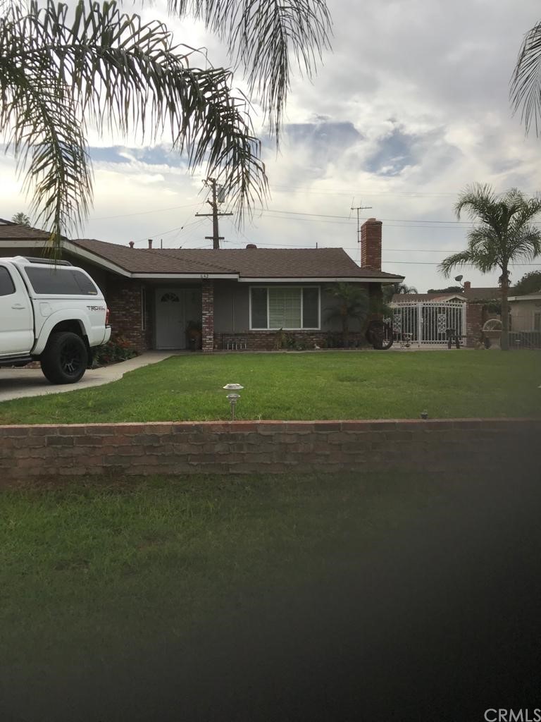 642 Flynn Street Riverside, CA 92507 - Photo 1 of 1 a front view of a house with a garden and trees