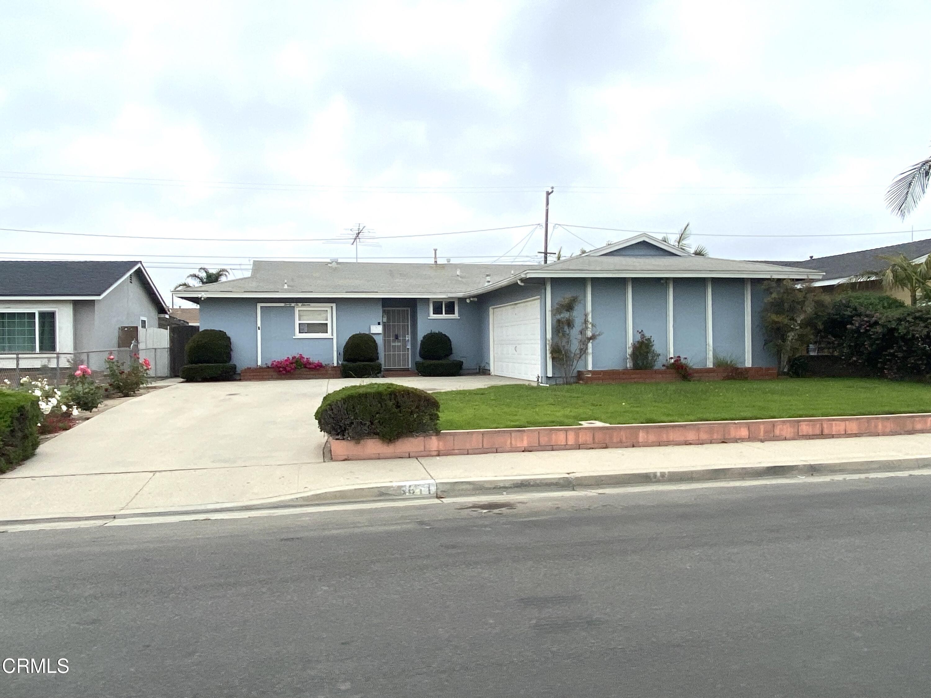 a view of house with yard and seating area