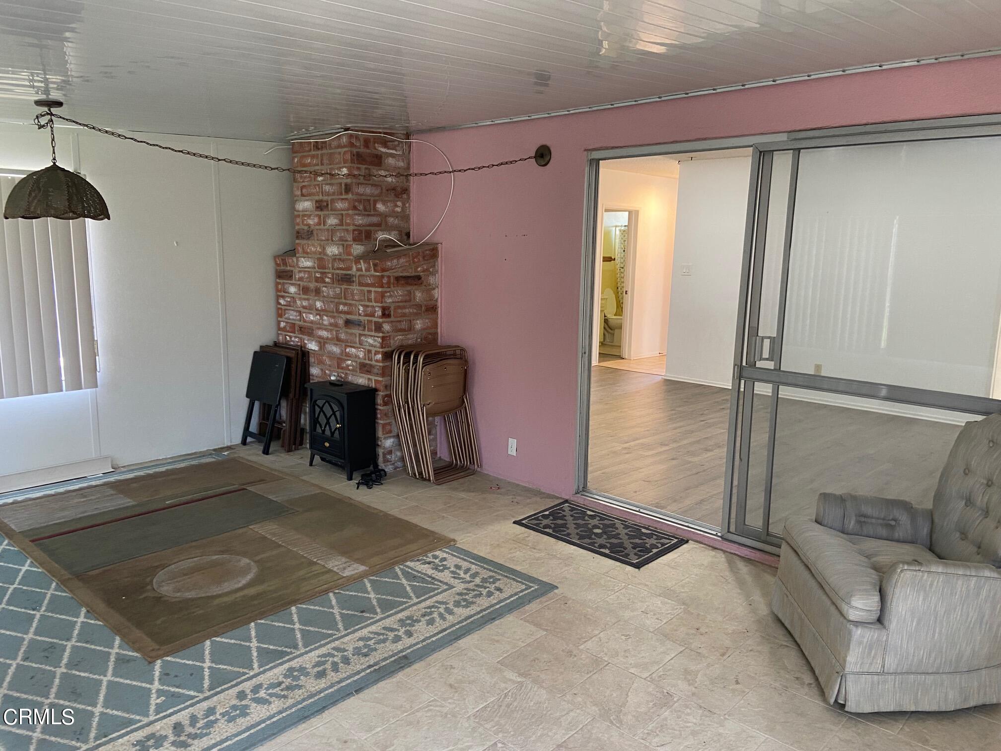 3611 South E Street Oxnard, CA 93033 - Photo 11 of 14 a room with a bed and a couch