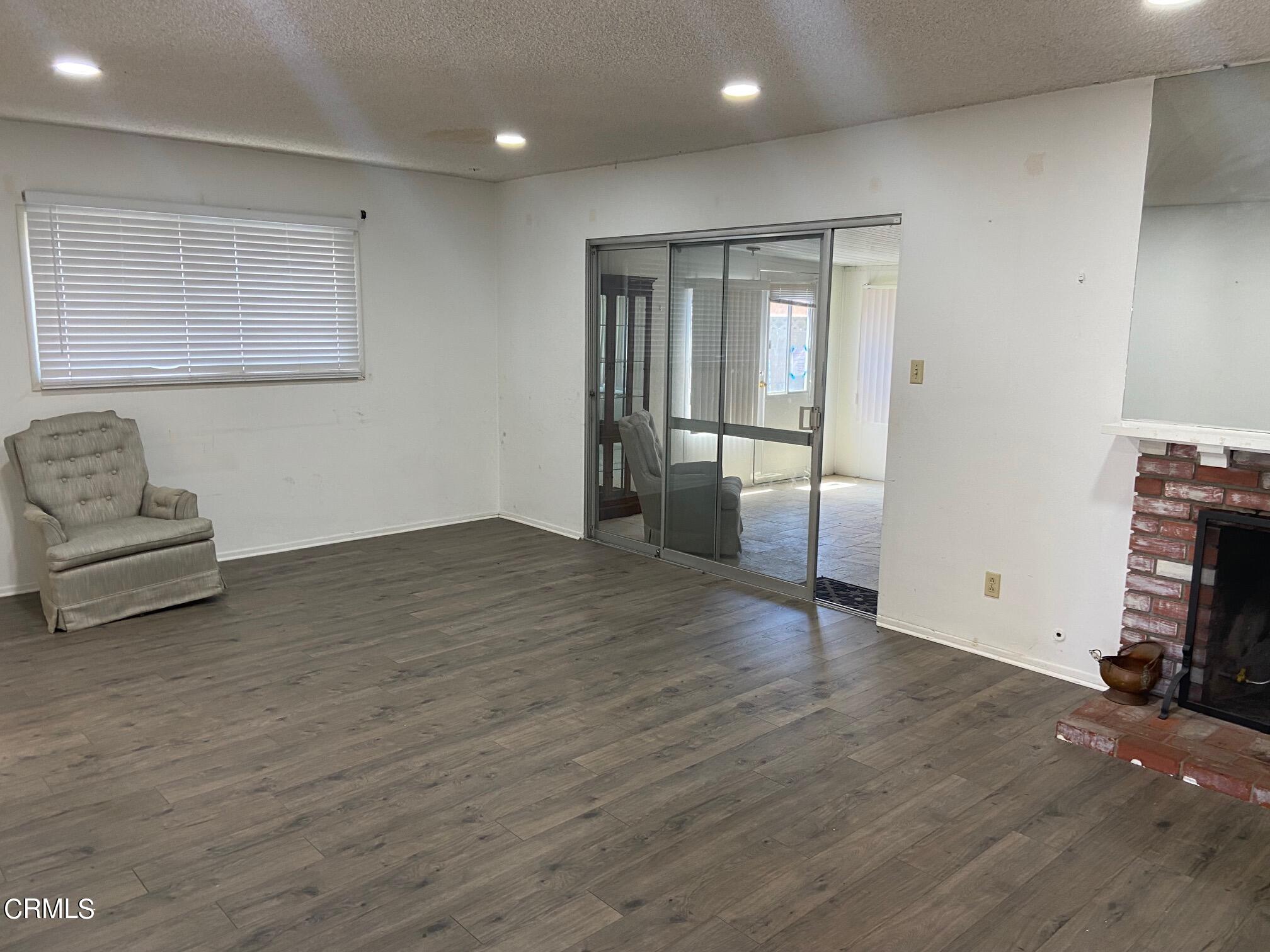3611 South E Street Oxnard, CA 93033 - Photo 3 of 14 a view of livingroom with hardwood floor and a ceiling fan