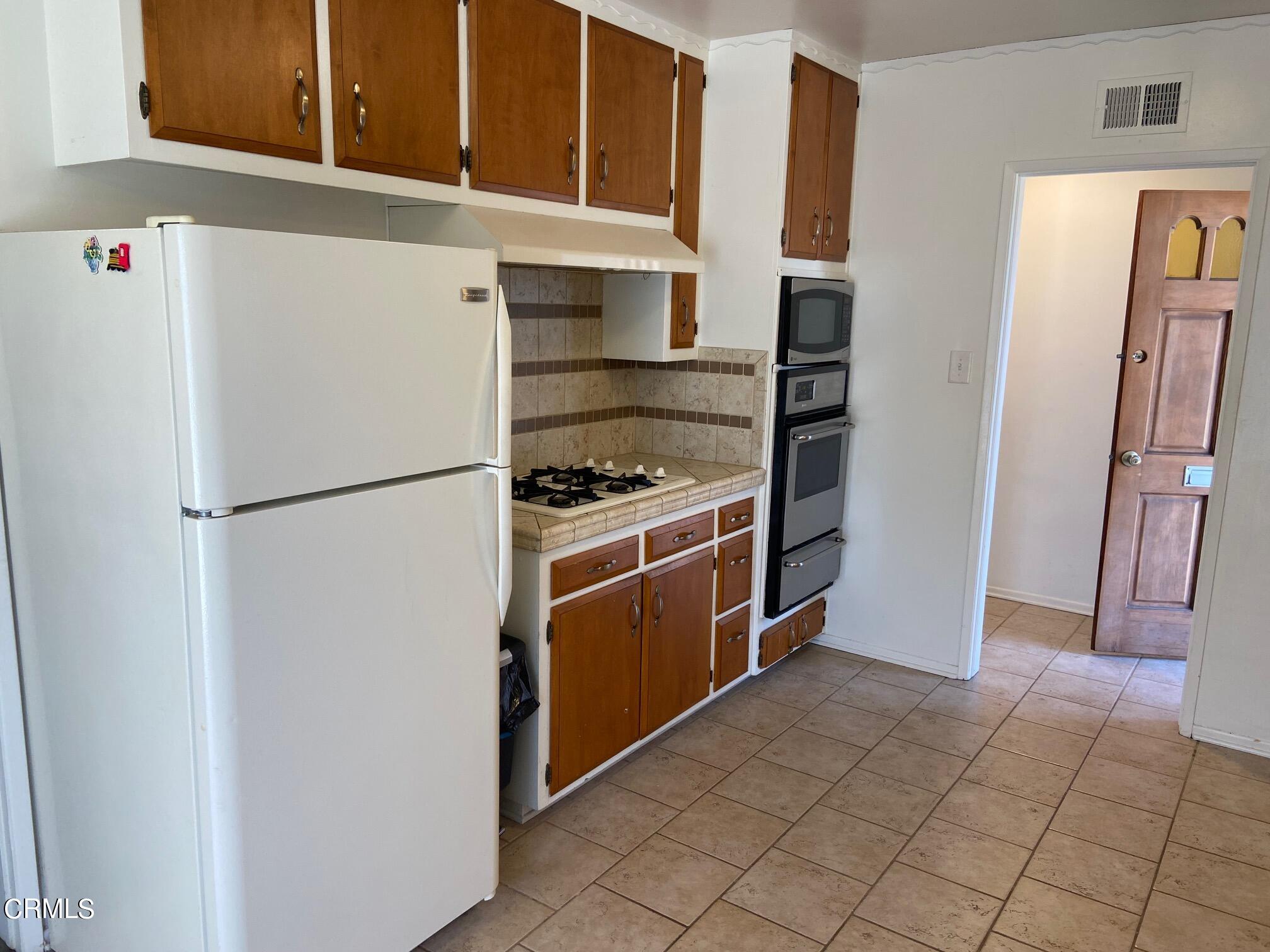 3611 South E Street Oxnard, CA 93033 - Photo 4 of 14 a kitchen with a refrigerator and a stove