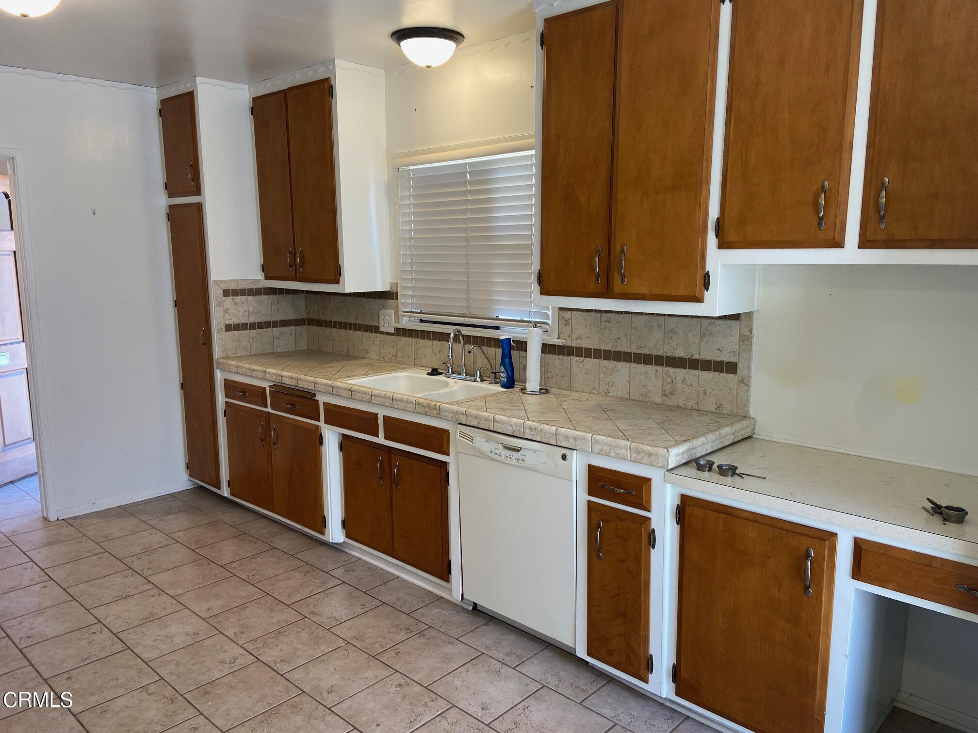 3611 South E Street Oxnard, CA 93033 - Photo 5 of 14 a kitchen with stainless steel appliances granite countertop a sink and a stove