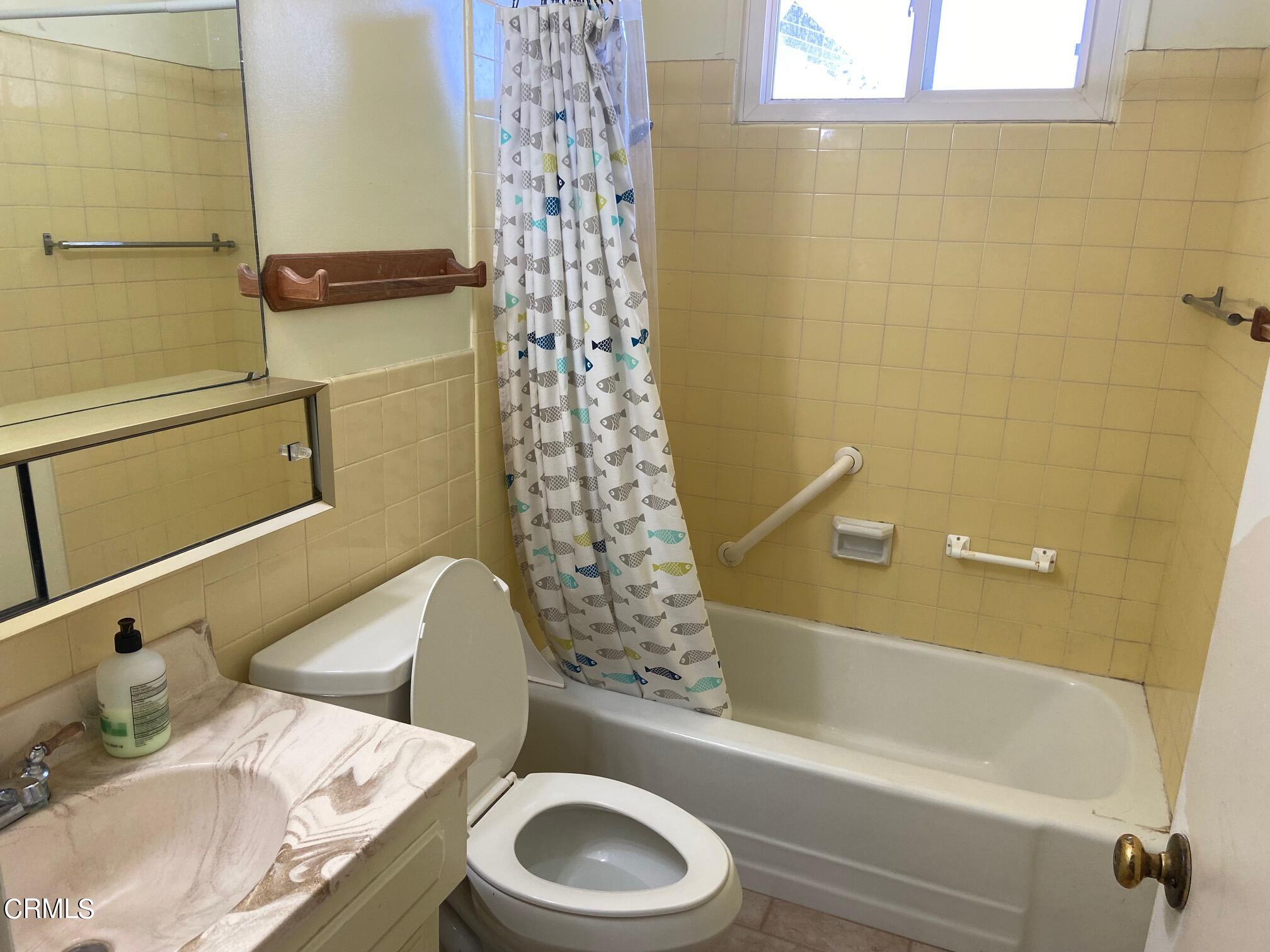3611 South E Street Oxnard, CA 93033 - Photo 9 of 14 a bathroom with a granite countertop bathtub sink vanity mirror and toilet