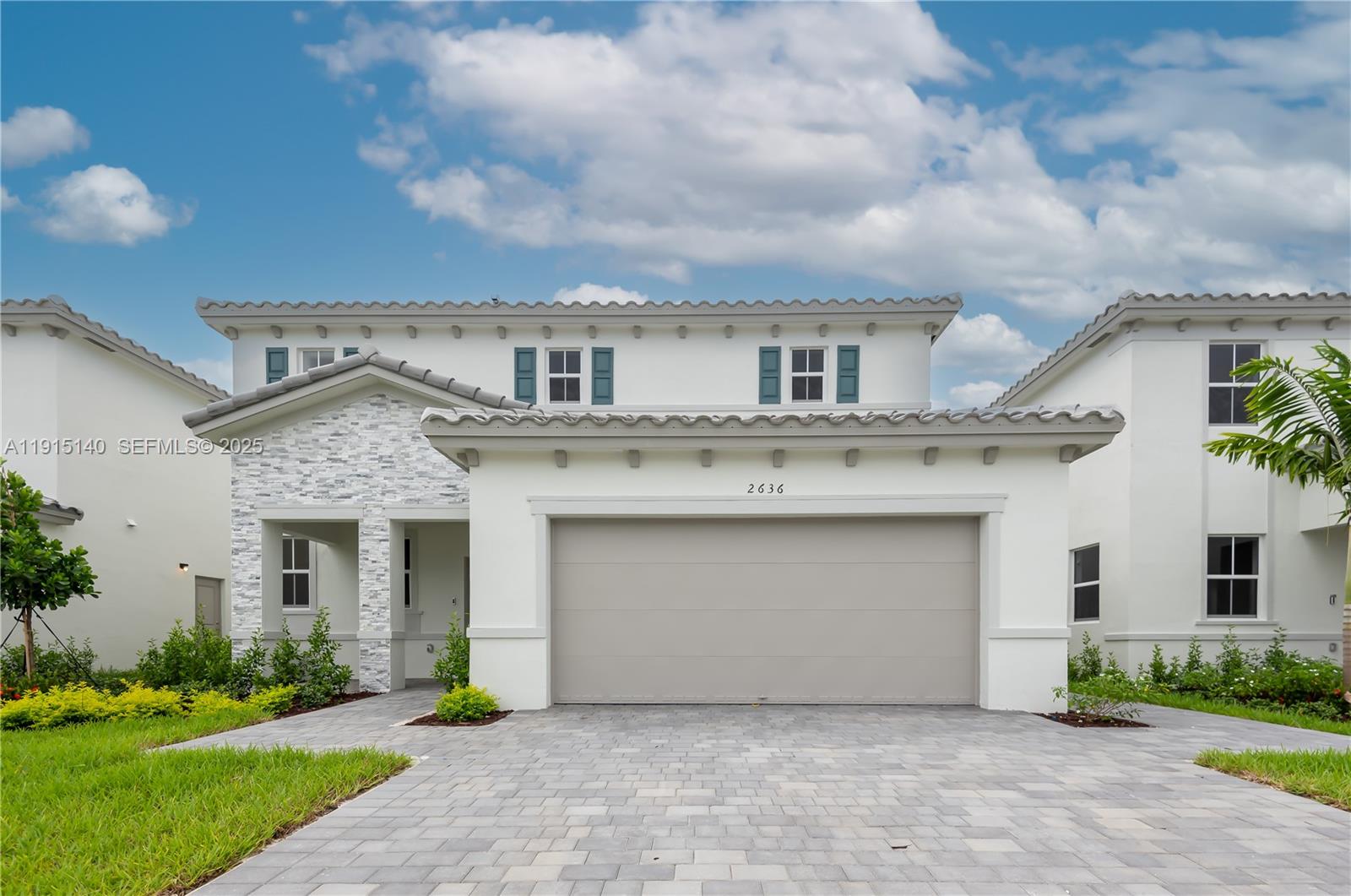 2636 Southeast 8th Court Homestead, FL 33035 - Photo 1 of 49 a front view of a house with a garden and garage