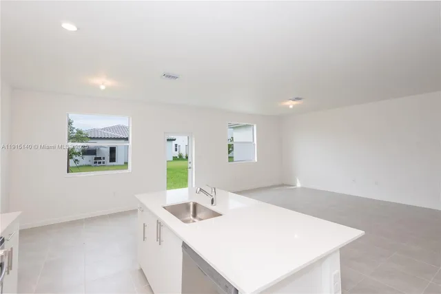a kitchen with a sink cabinets and a wooden floor
