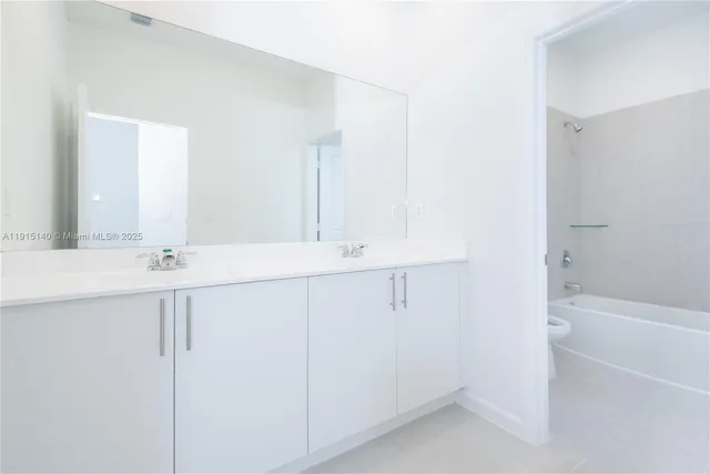 a bathroom with a sink a mirror and a bathtub