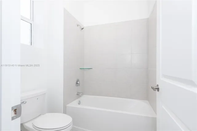 a white bath tub sitting next to a white toilet