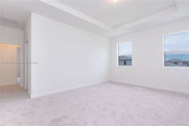 an empty room with a empty space and windows