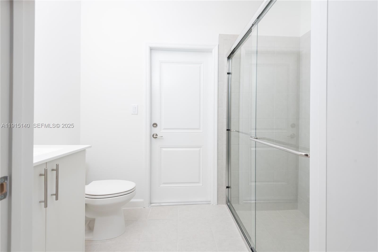 2636 Southeast 8th Court Homestead, FL 33035 - Photo 6 of 49 a bathroom with a shower a toilet and a sink