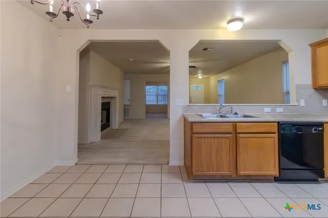 a spacious bathroom with a granite countertop sink a mirror and a vanity
