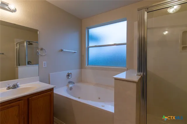 a bathroom with a bathtub and a sink