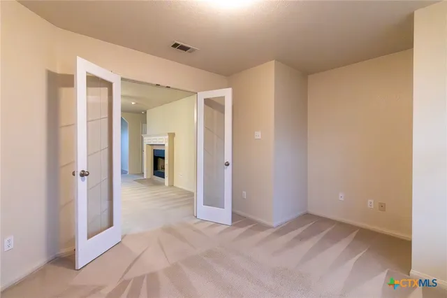 a view of a hallway with wooden floor and a kitchen