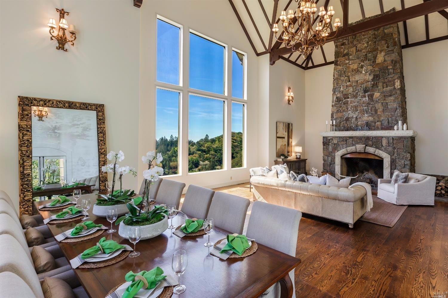 a living room with furniture fireplace and a large window