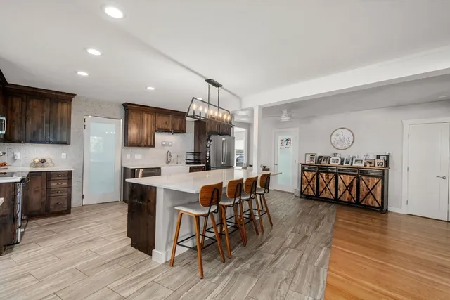 a view of kitchen with sink microwave and cabinets