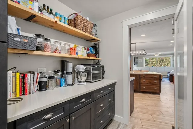a kitchen with appliances cabinets and a large window